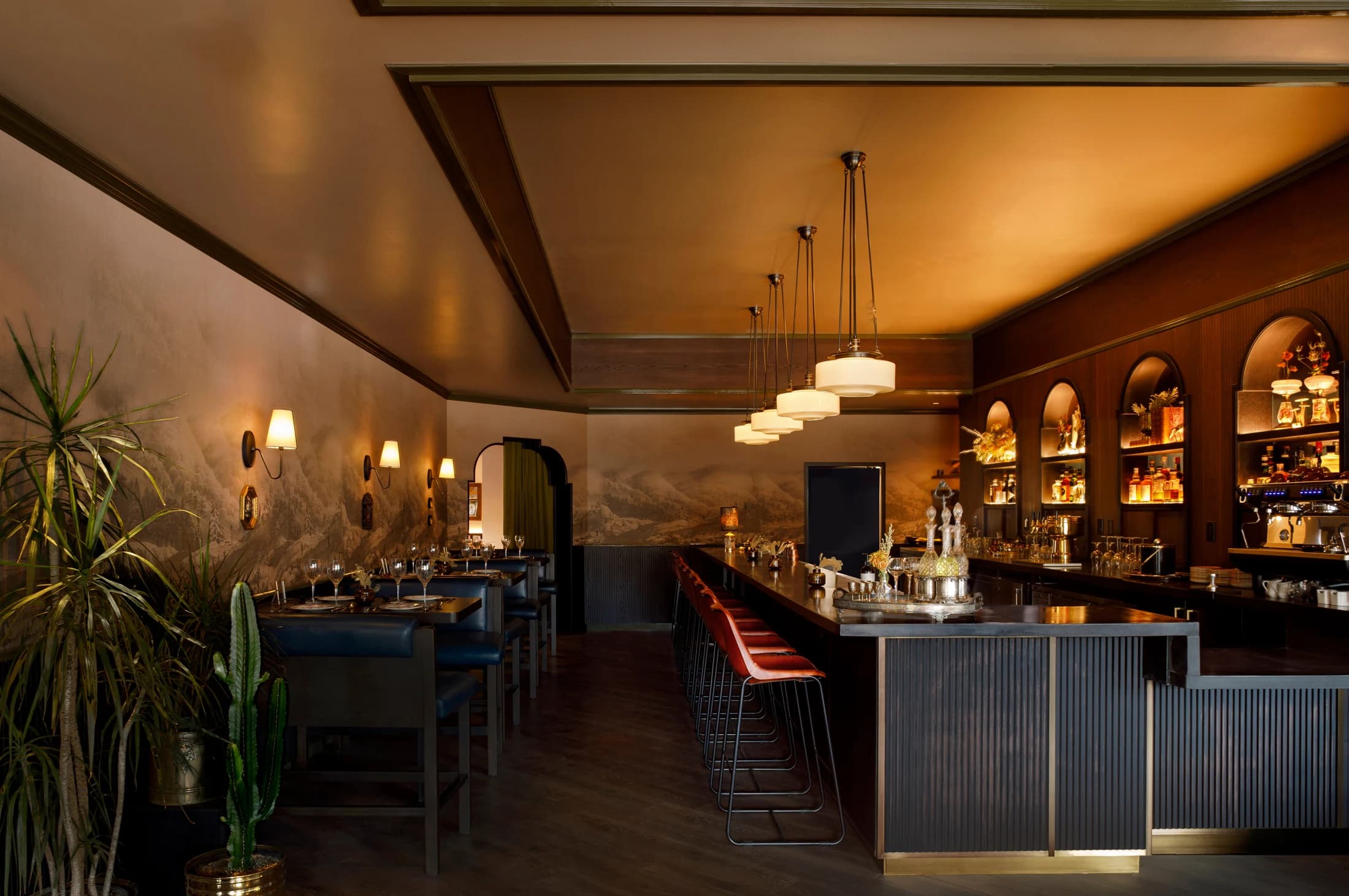 Warm woodwork and intimate seating at the Wildflower bar in Denver